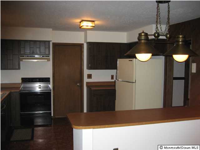 397 Leesville Road Jackson, NJ 08527 - Photo 16 of 18 a kitchen with refrigerator and cabinets