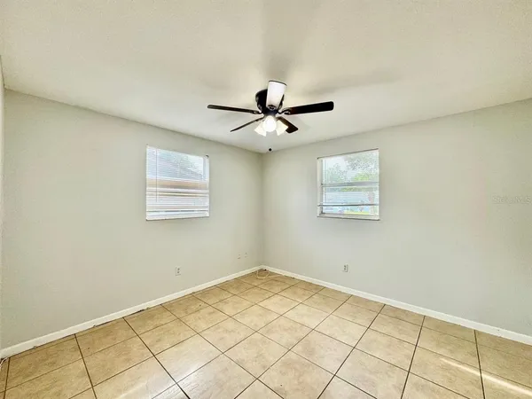 a view of a room with window and ceiling fan