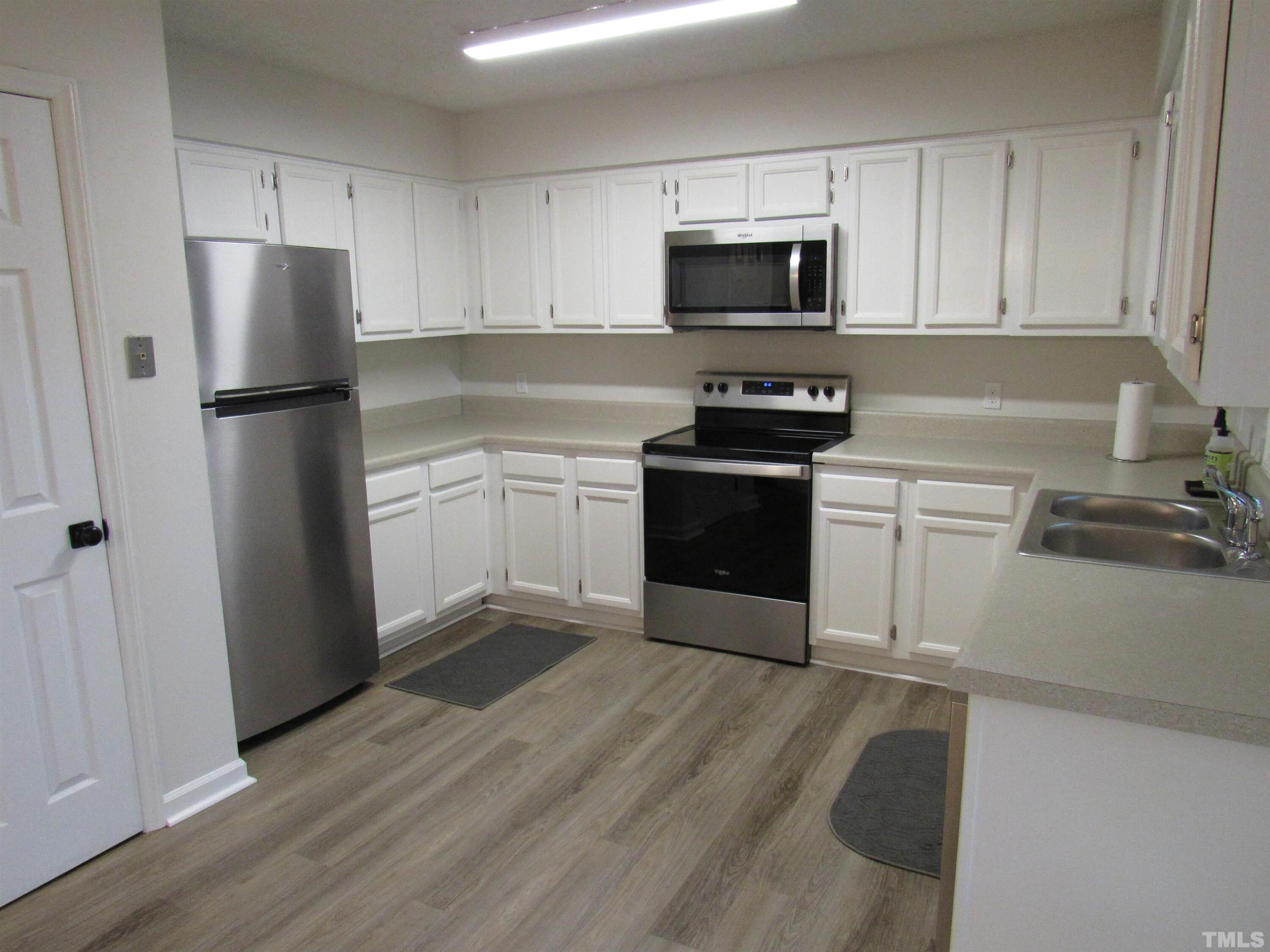 4309 Hunters Club Drive, Unit 4309 Raleigh, NC 27606 - Photo 16 of 35 a kitchen with a refrigerator stove and microwave