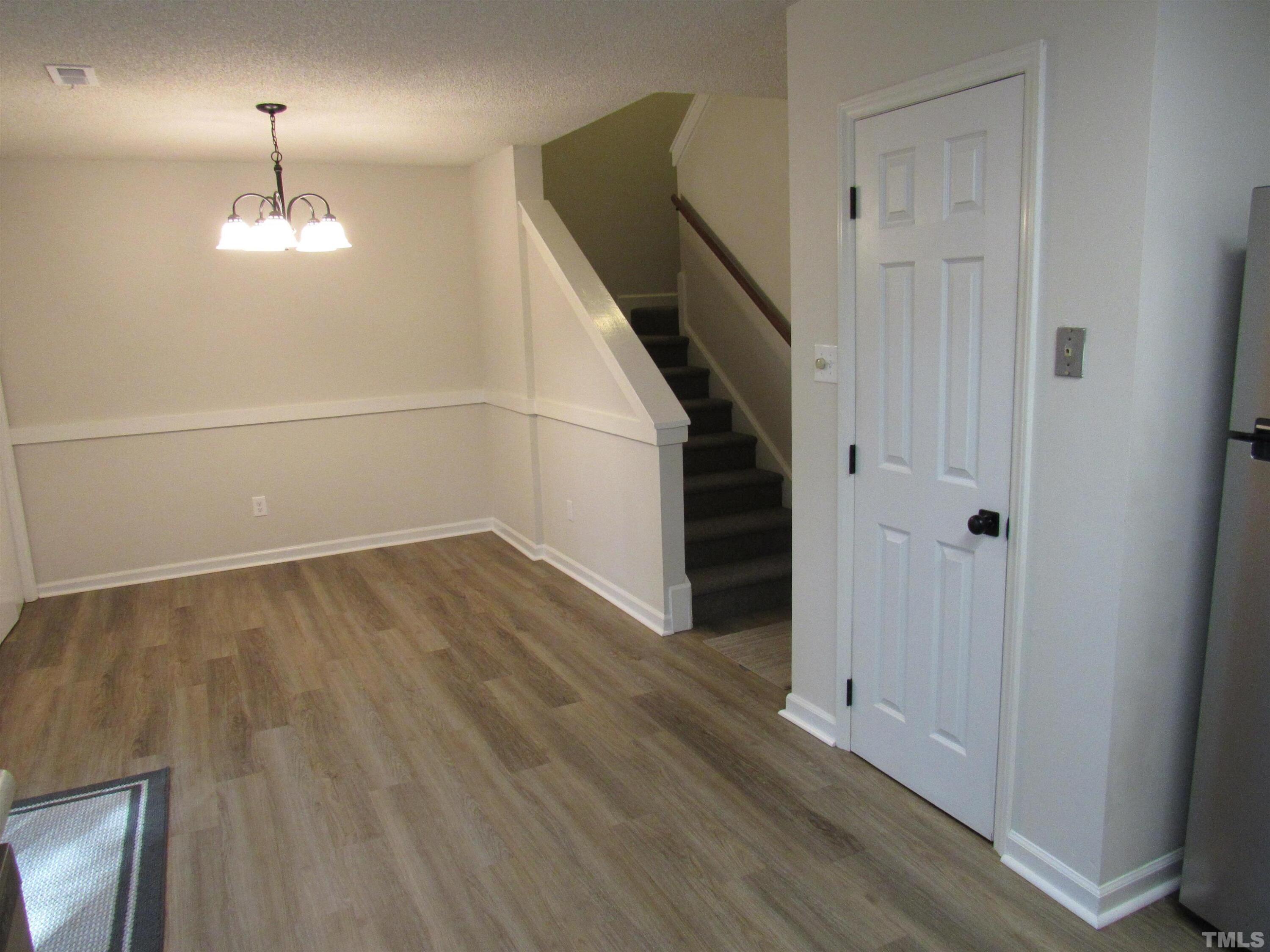 4309 Hunters Club Drive, Unit 4309 Raleigh, NC 27606 - Photo 17 of 35 wooden floor in an empty room with a window