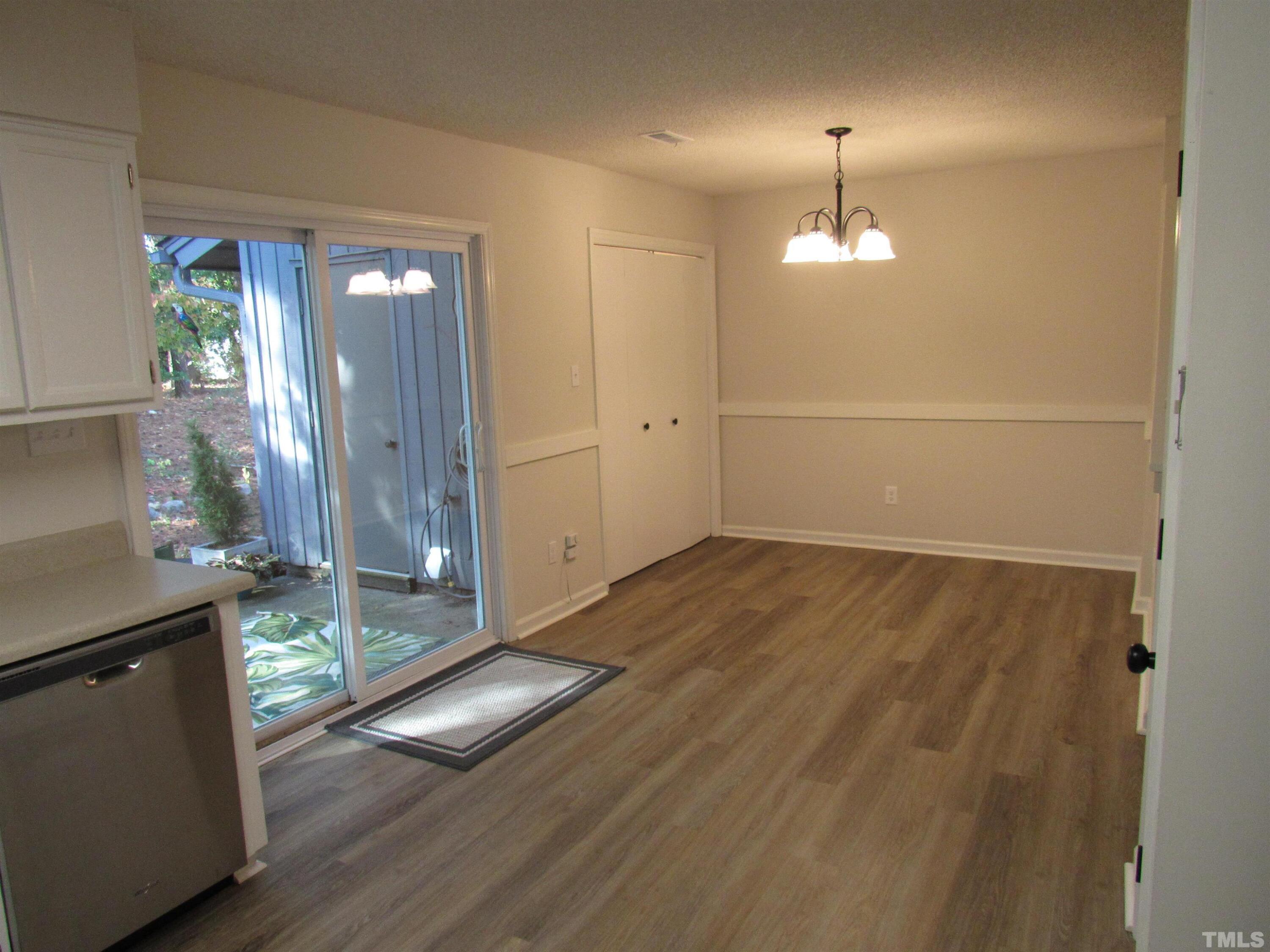 4309 Hunters Club Drive, Unit 4309 Raleigh, NC 27606 - Photo 18 of 35 an empty room with wooden floor and mirror