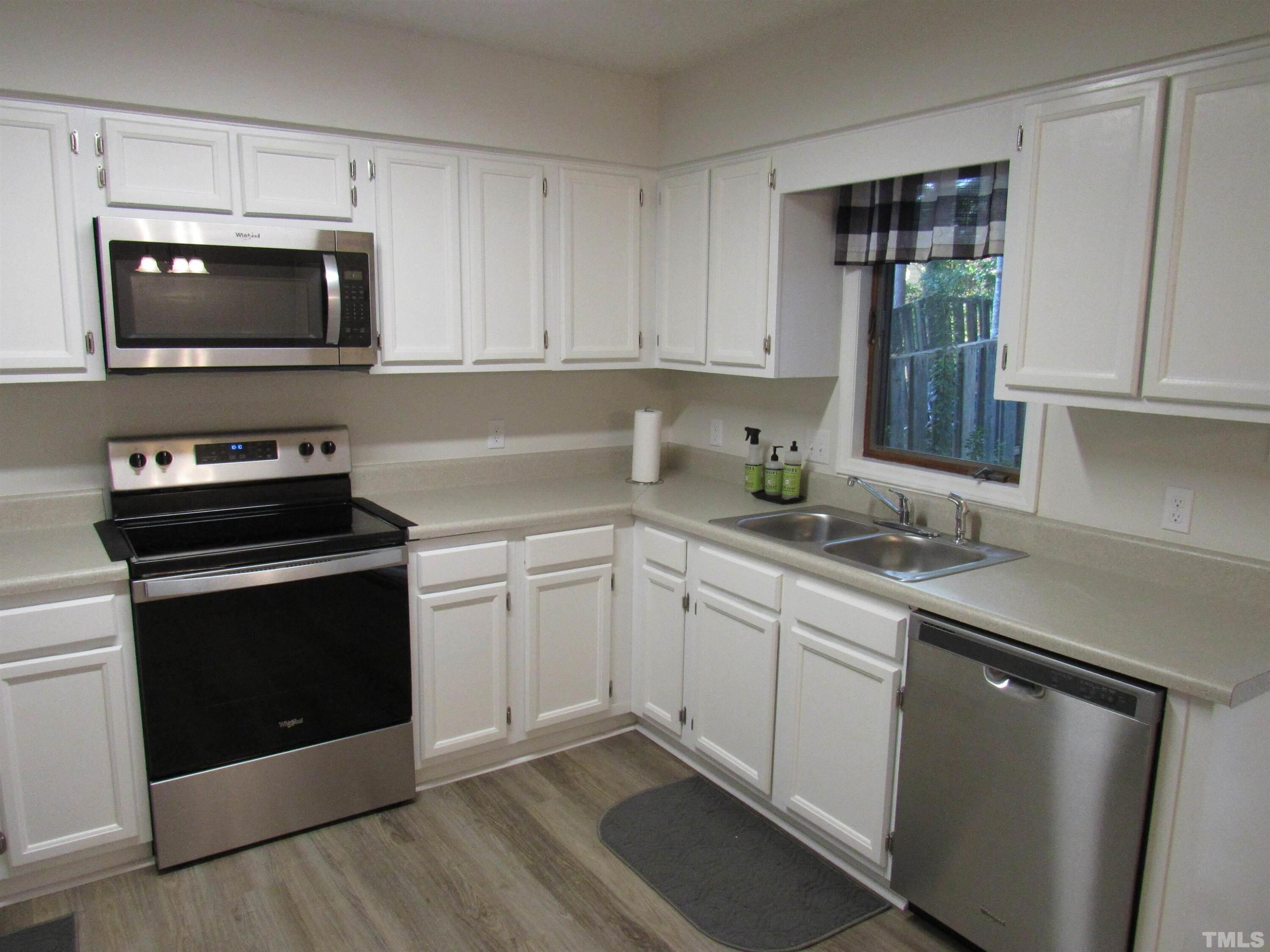 4309 Hunters Club Drive, Unit 4309 Raleigh, NC 27606 - Photo 19 of 35 a kitchen with a sink stove and microwave