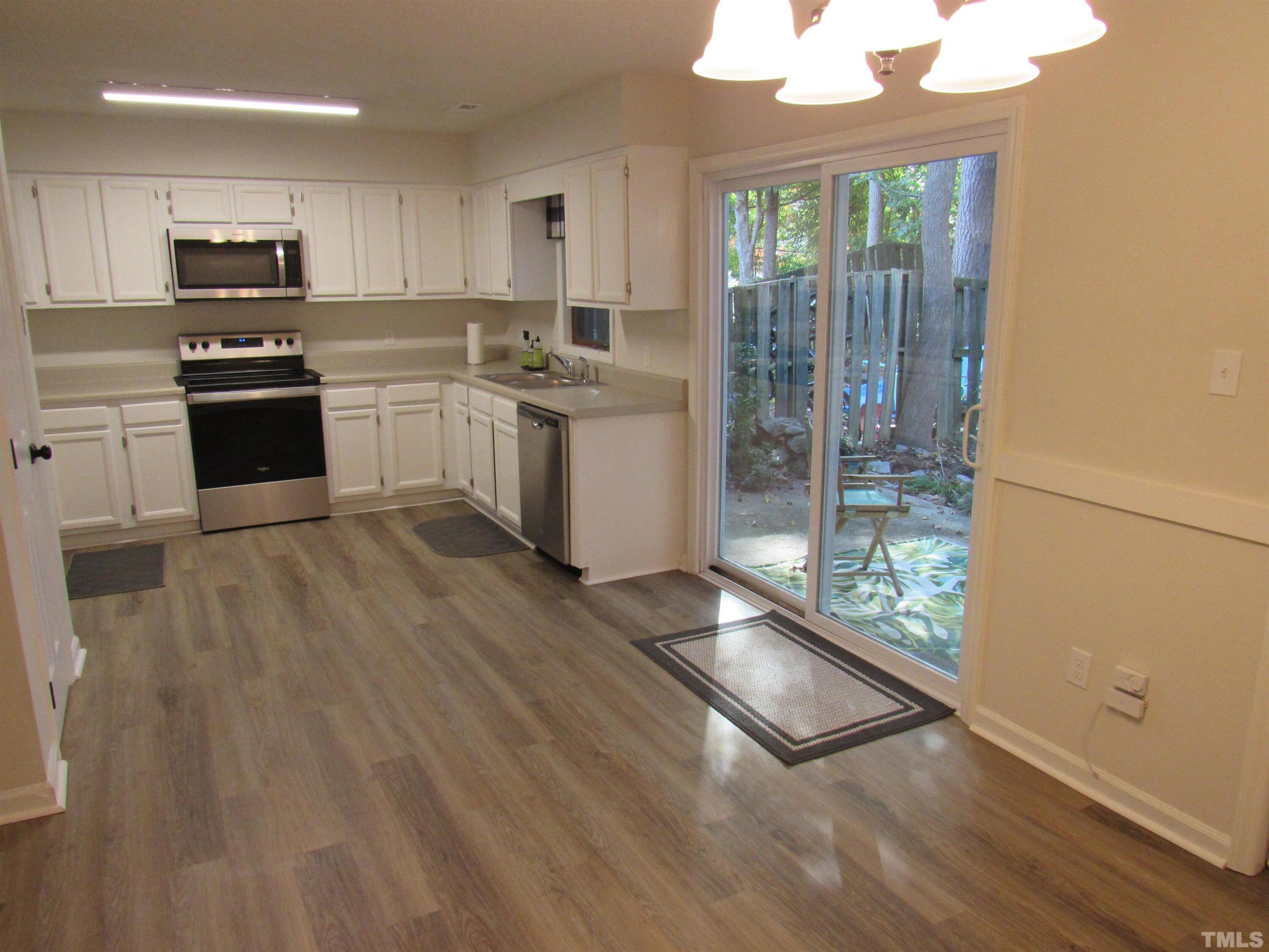 4309 Hunters Club Drive, Unit 4309 Raleigh, NC 27606 - Photo 21 of 35 a kitchen with stainless steel appliances granite countertop a stove a sink and a refrigerator