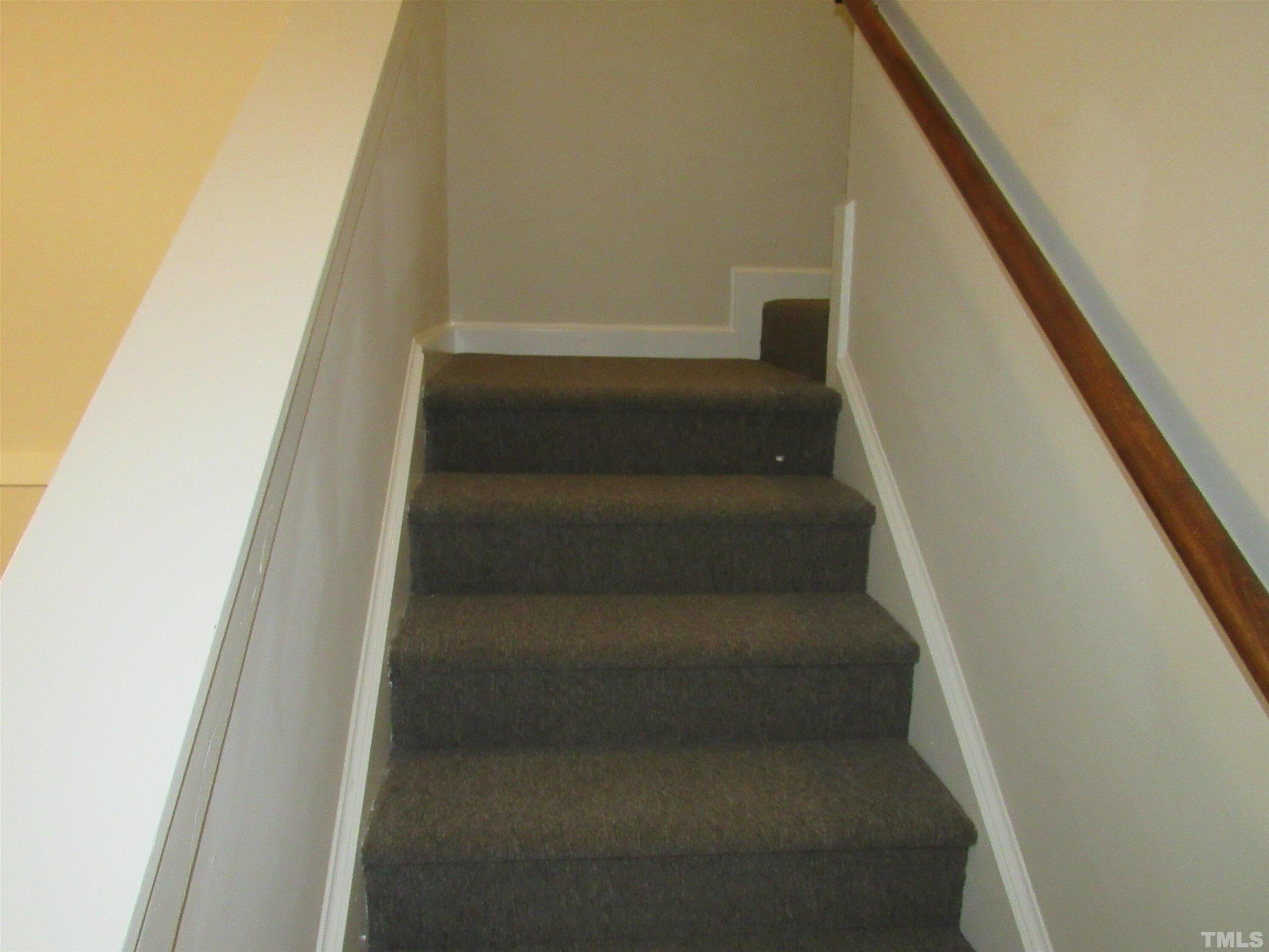4309 Hunters Club Drive, Unit 4309 Raleigh, NC 27606 - Photo 24 of 35 a view of staircase with lots of frames on wall