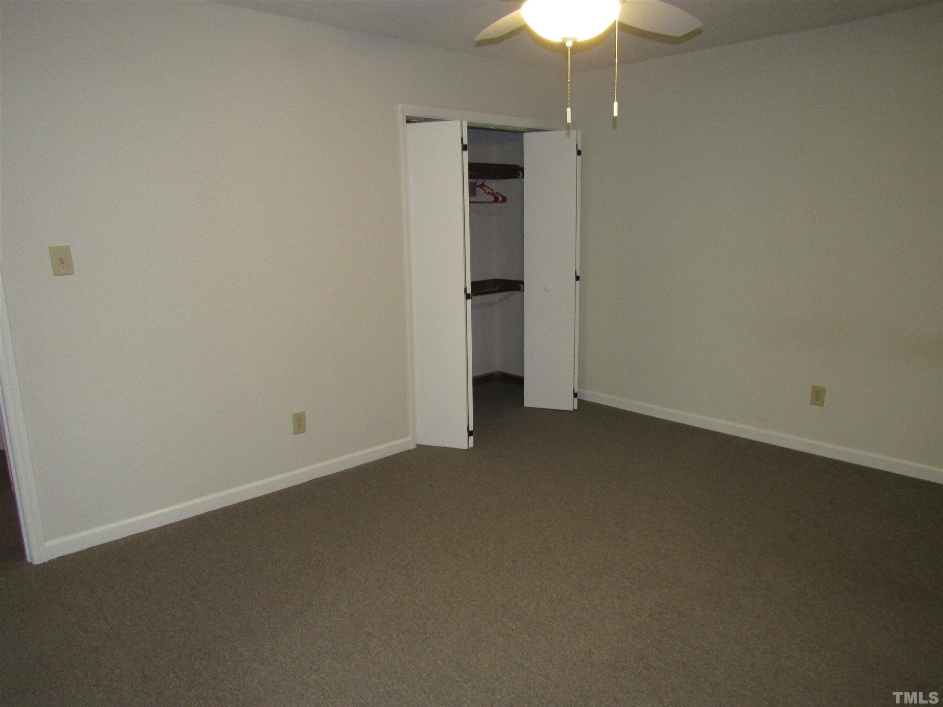 4309 Hunters Club Drive, Unit 4309 Raleigh, NC 27606 - Photo 26 of 35 an empty room with a empty space and a ceiling fan