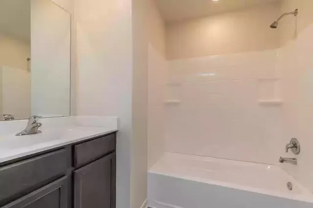 a bath room with a sink and a bath tub