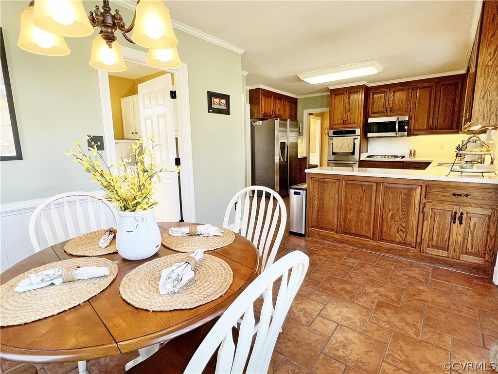 13330 West Salisbury Road Midlothian, VA 23113 - Photo 12 of 50 a kitchen with stainless steel appliances granite countertop a table chairs and a refrigerator