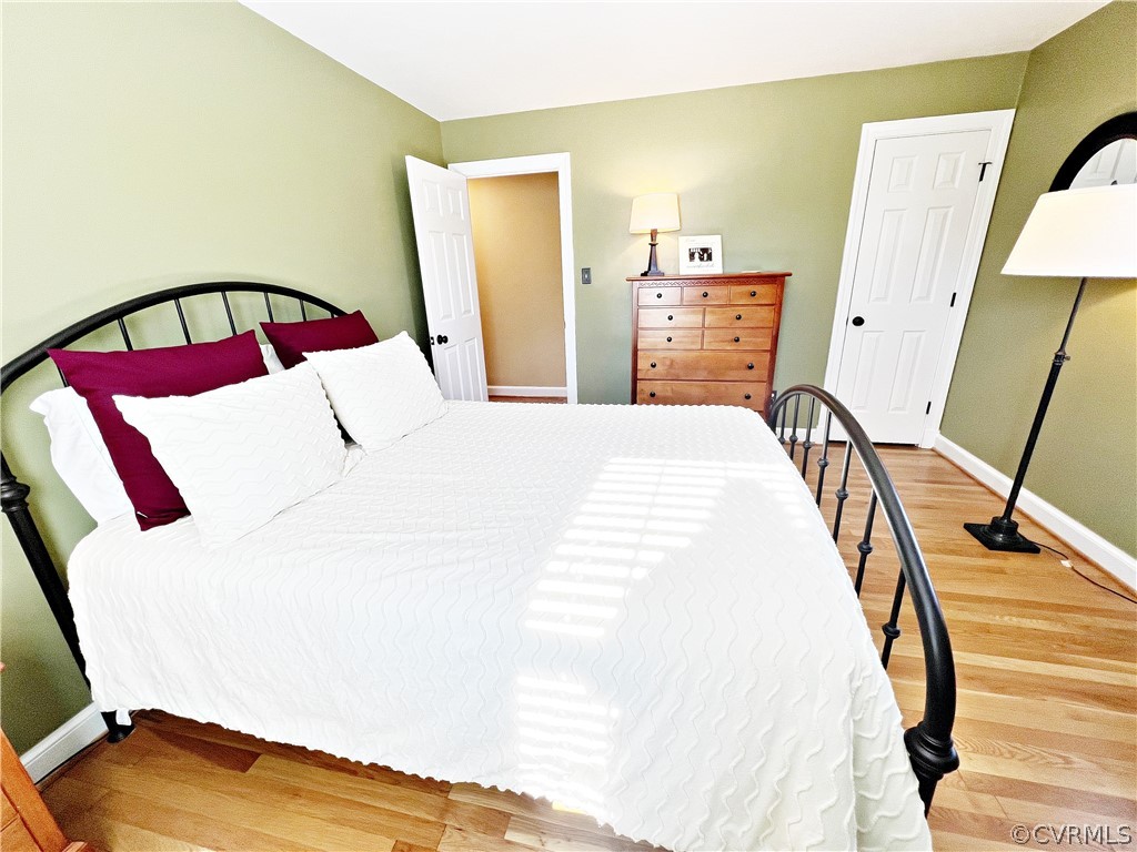 13330 West Salisbury Road Midlothian, VA 23113 - Photo 26 of 50 a bedroom with a bed next to a window with wooden floor