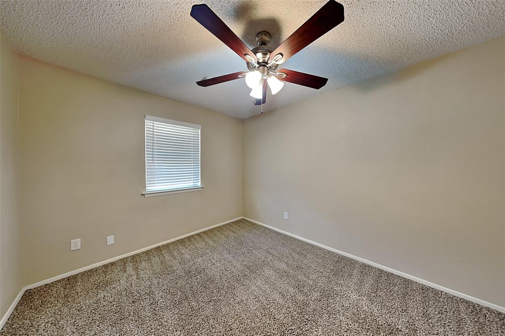 433 Arwine Drive Hurst, TX 76053 - Photo 11 of 18 an empty room with window and ceiling fan