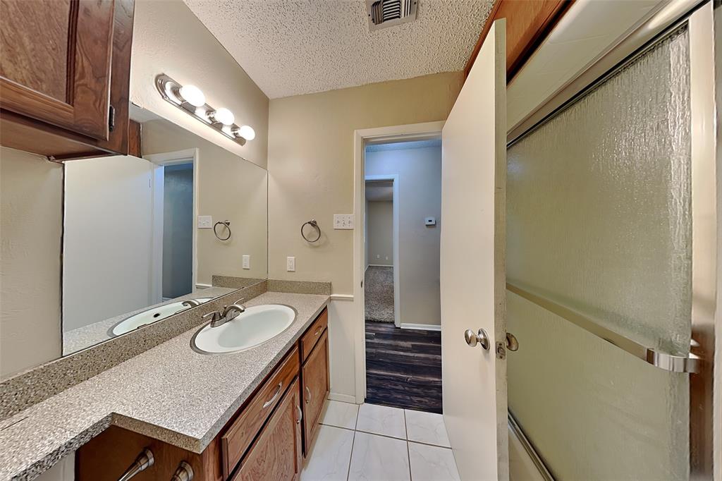 433 Arwine Drive Hurst, TX 76053 - Photo 16 of 18 a bathroom with a sink and a mirror