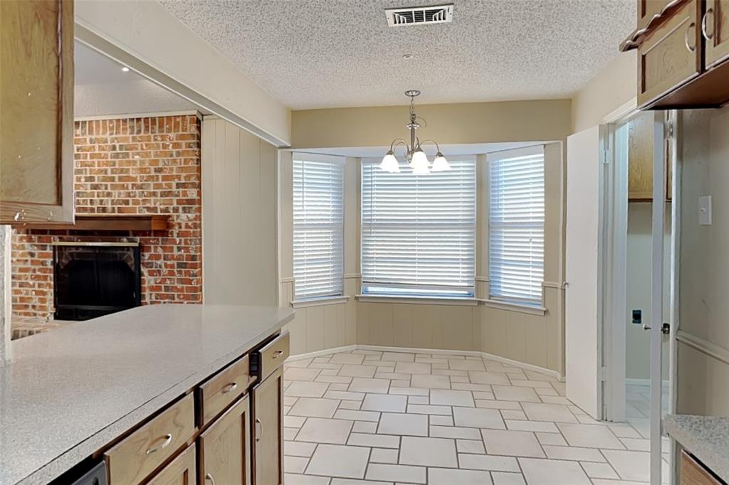 433 Arwine Drive Hurst, TX 76053 - Photo 5 of 18 a kitchen with windows and fireplace