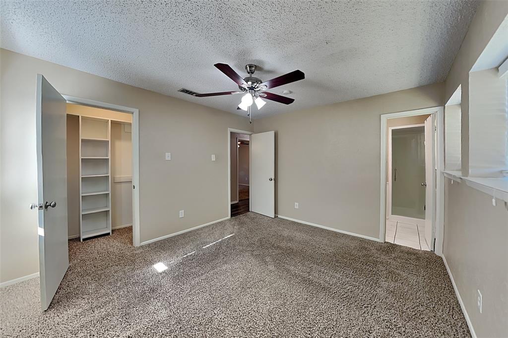 433 Arwine Drive Hurst, TX 76053 - Photo 6 of 18 an empty room with closet and a ceiling fan