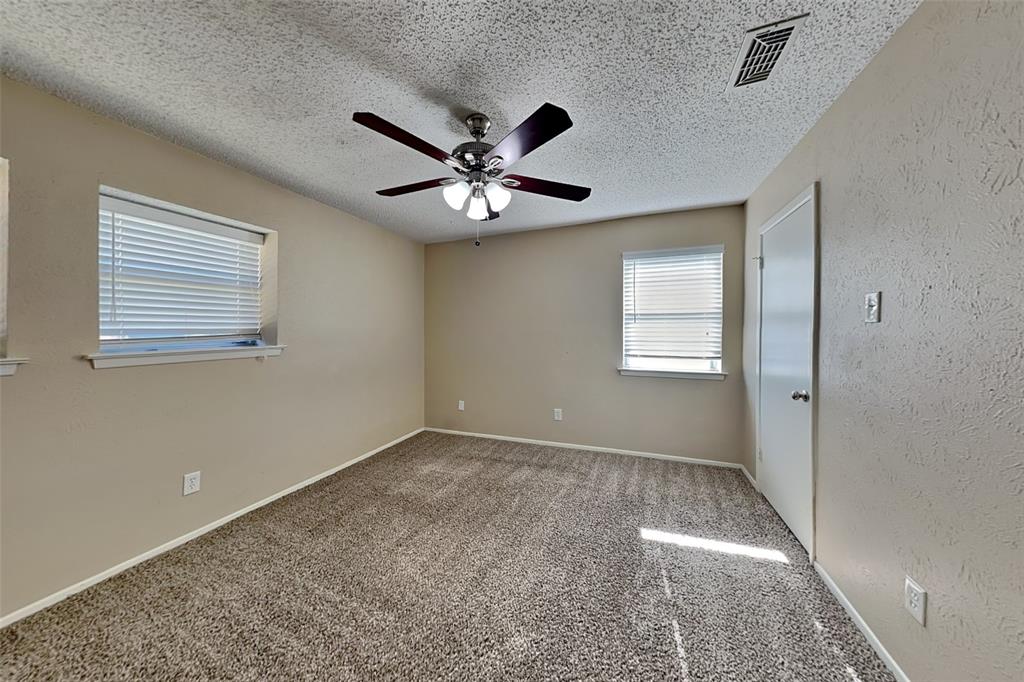 433 Arwine Drive Hurst, TX 76053 - Photo 8 of 18 a view of an empty room with a ceiling fan