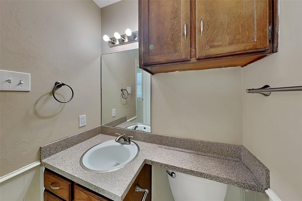433 Arwine Drive Hurst, TX 76053 - Photo 9 of 18 a bathroom with a granite countertop sink and a mirror