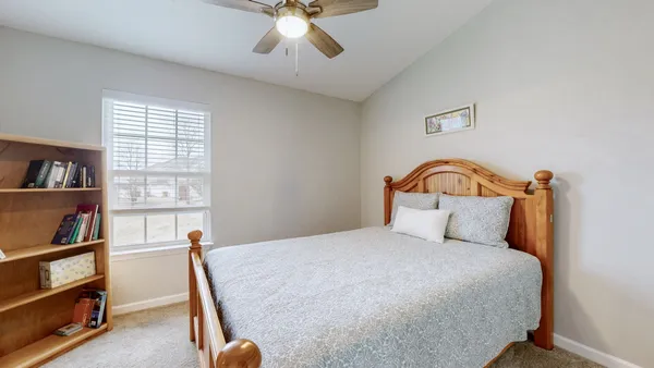 a bedroom with a bed and a book shelf