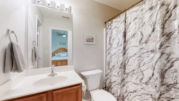 a bathroom with a sink and a mirror with toilet