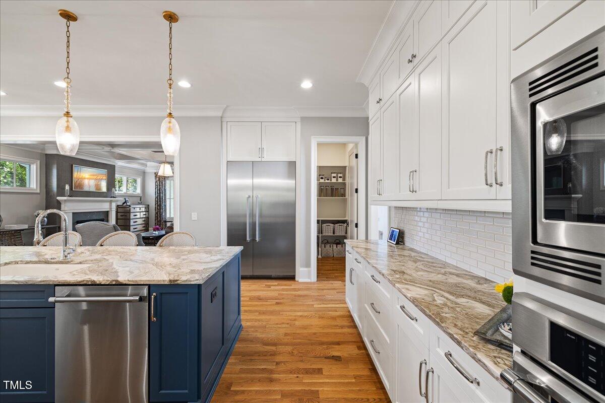 3513 Bellevue Road Raleigh, NC 27609 - Photo 13 of 61 a large kitchen with granite countertop a large counter top appliances and cabinets