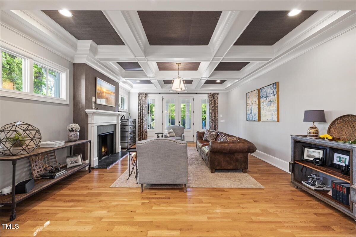 3513 Bellevue Road Raleigh, NC 27609 - Photo 20 of 61 a living room with furniture a fireplace and a flat screen tv