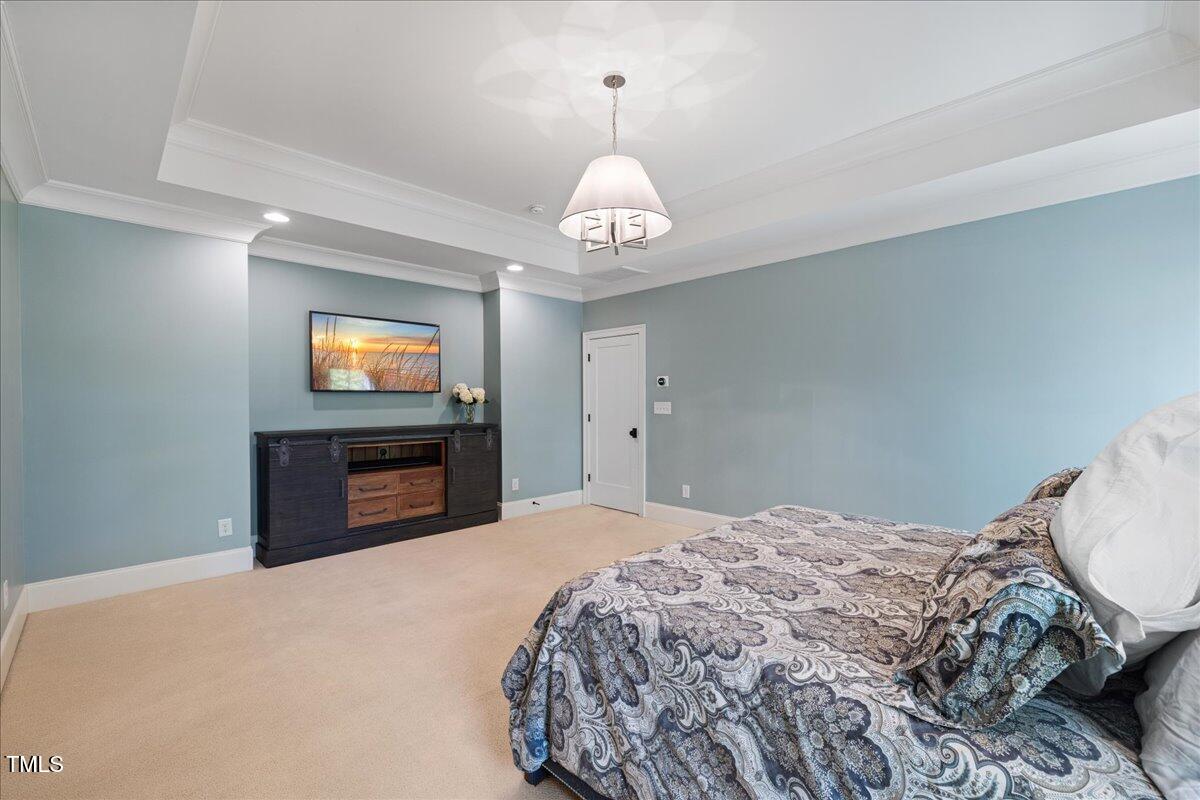 3513 Bellevue Road Raleigh, NC 27609 - Photo 30 of 61 a bedroom with a bed and a flat screen tv