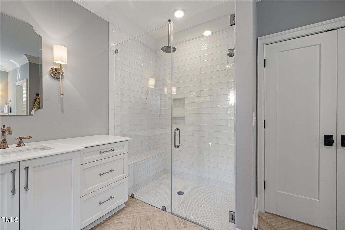 3513 Bellevue Road Raleigh, NC 27609 - Photo 34 of 61 a bathroom with a shower sink and mirror