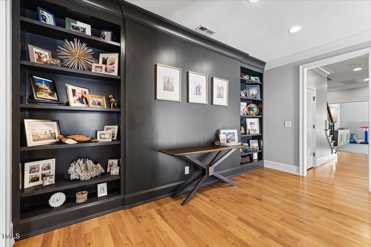 3513 Bellevue Road Raleigh, NC 27609 - Photo 43 of 61 a room with lots of books and a book shelf