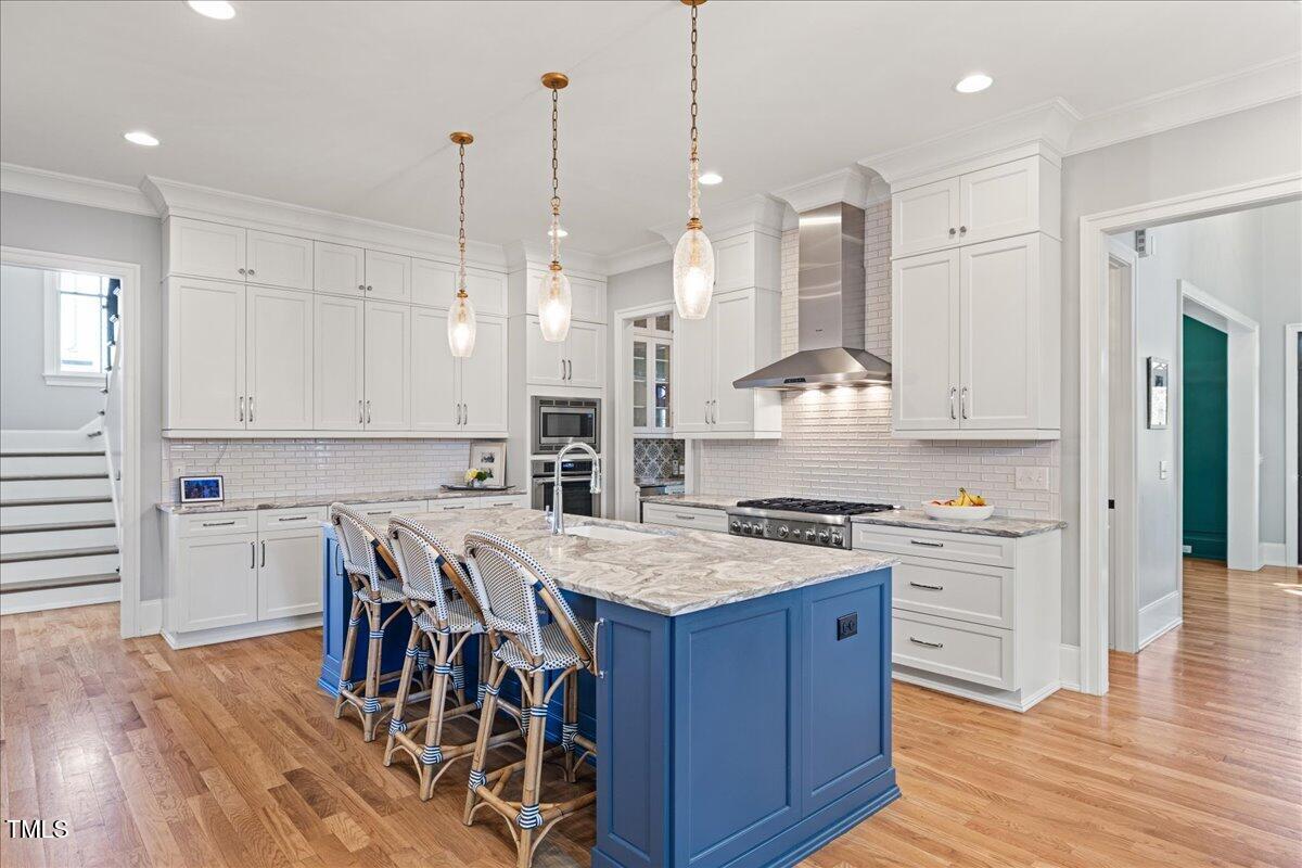 3513 Bellevue Road Raleigh, NC 27609 - Photo 10 of 61 a kitchen with a stove a refrigerator a sink and chairs