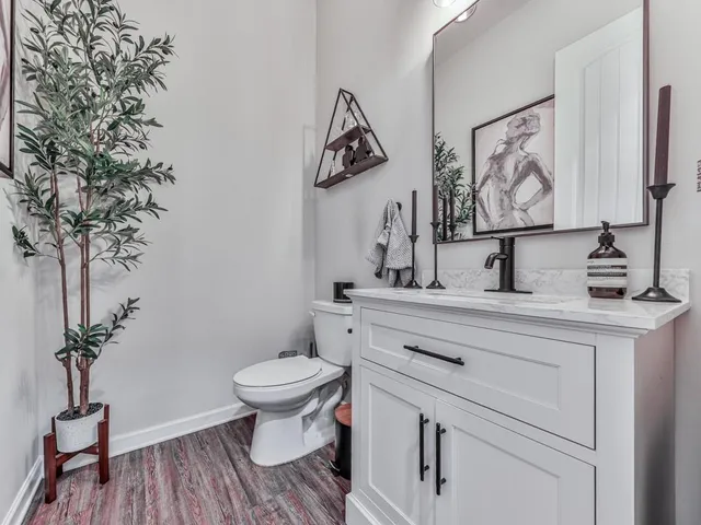 a bathroom with a toilet sink and mirror
