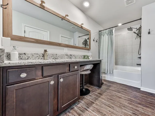 a bathroom with a sink a vanity and a mirror