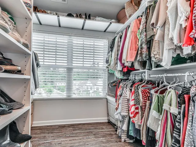a view of walk in closet with clothes