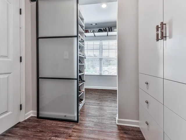 a view of empty room with wooden floor