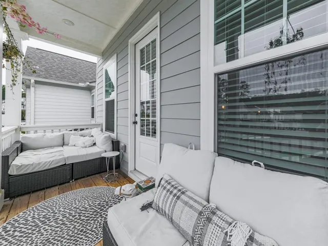 a balcony with furniture and a potted plant