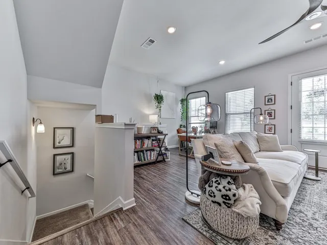 a living room with furniture couches and a large window