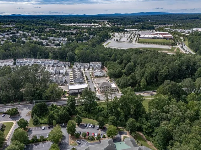 an aerial view of a house with a yard