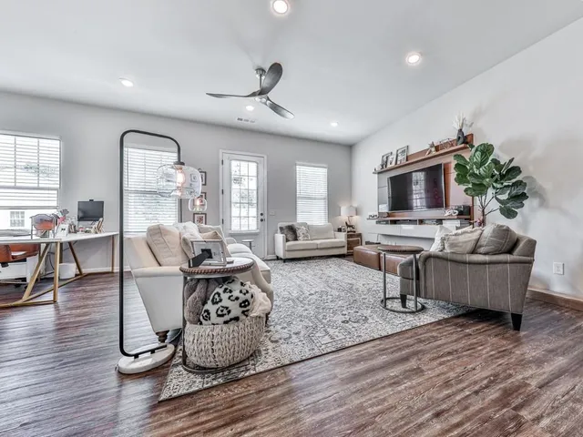 a living room with furniture and wooden floor