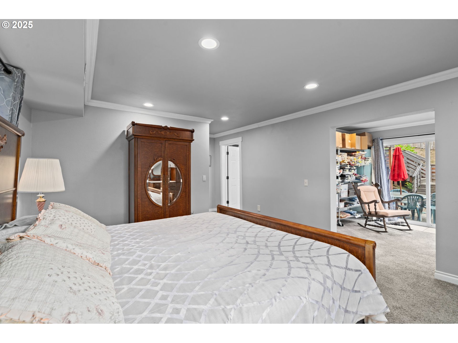 5944 Southwest Wilbard Street Portland, OR 97219 - Photo 11 of 21 a bedroom with a bed and a large mirror