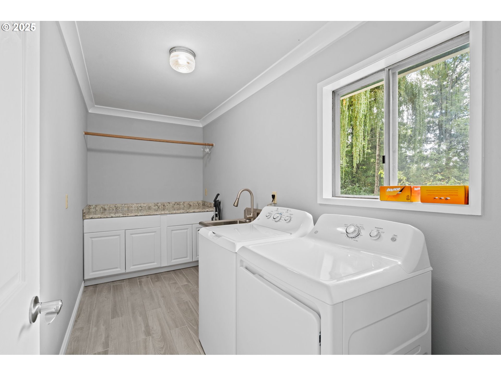 5944 Southwest Wilbard Street Portland, OR 97219 - Photo 15 of 21 a utility room with cabinets washer and dryer