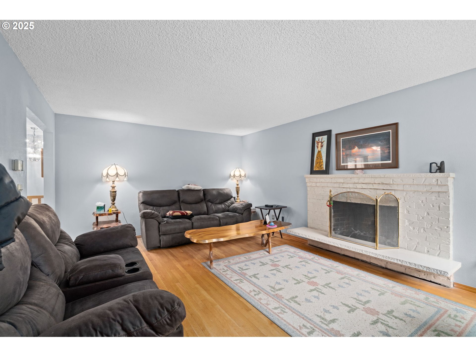 5944 Southwest Wilbard Street Portland, OR 97219 - Photo 2 of 21 a living room with furniture and a fireplace