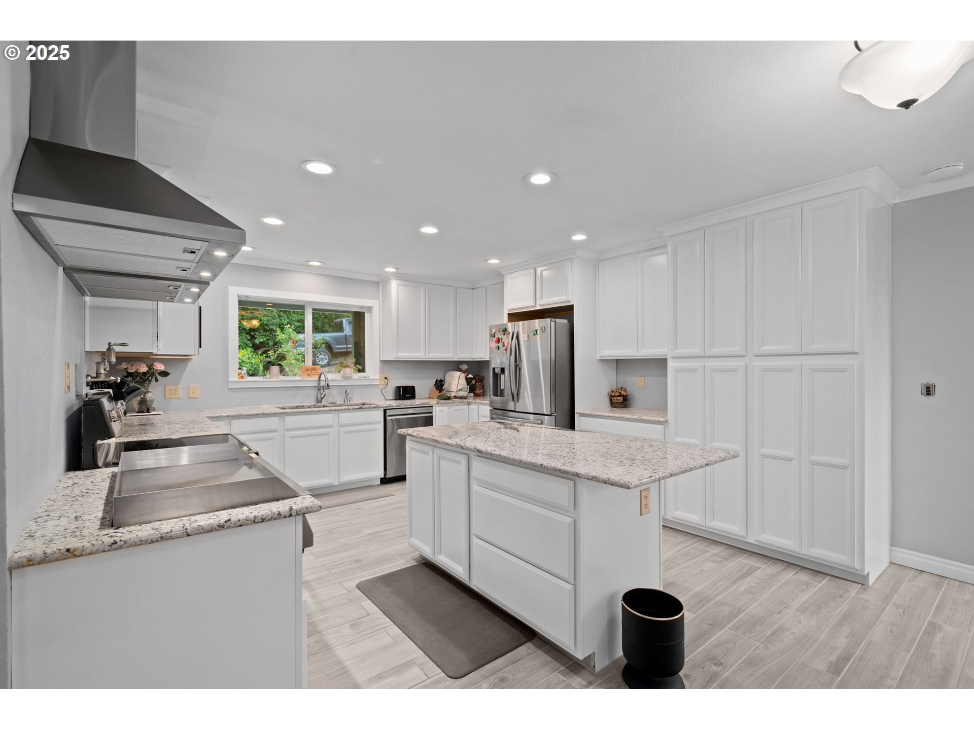 5944 Southwest Wilbard Street Portland, OR 97219 - Photo 4 of 21 a kitchen with white cabinets and sink