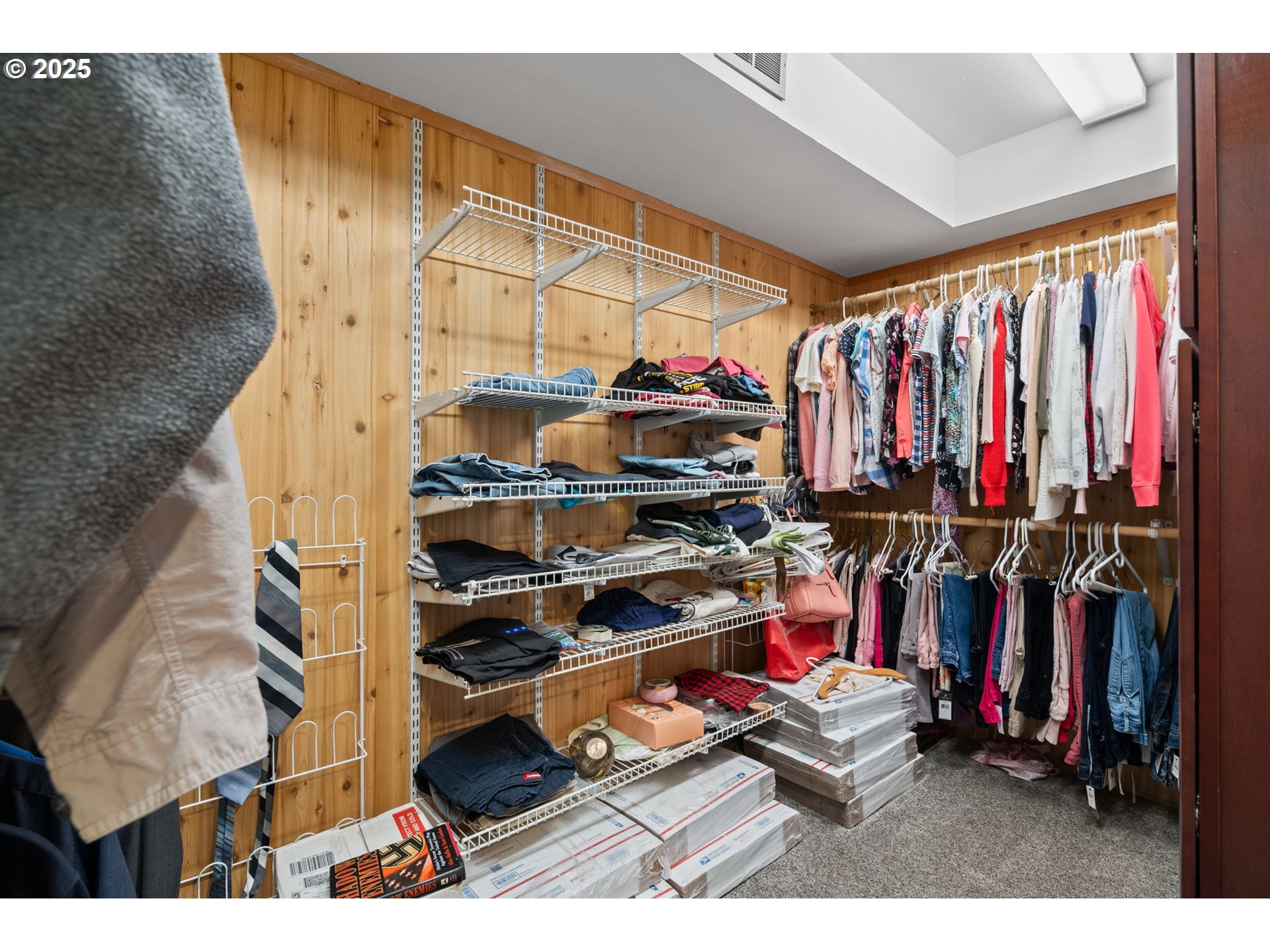 5944 Southwest Wilbard Street Portland, OR 97219 - Photo 8 of 21 a view of walk in closet with clothes and shoes