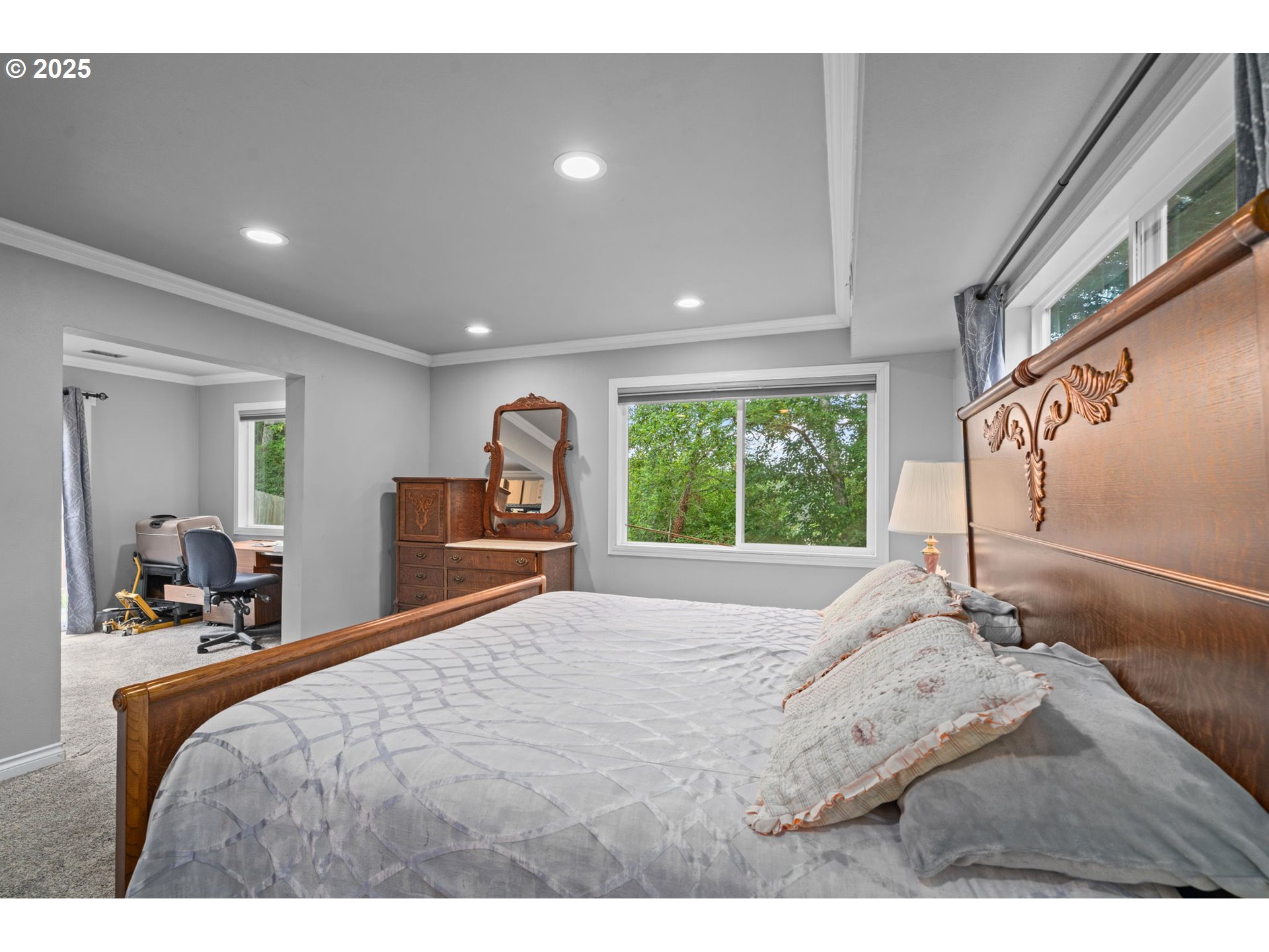 5944 Southwest Wilbard Street Portland, OR 97219 - Photo 10 of 21 a bedroom with a bed and a large window