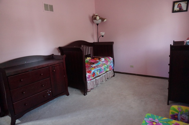 1315 Inverness Drive, Unit 1315 Elgin, IL 60120 - Photo 13 of 16 a bedroom with a bed and a dresser