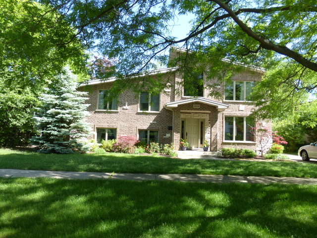 2928 Covert Road Glenview, IL 60025 - Photo 1 of 23 a front view of a house with garden and trees