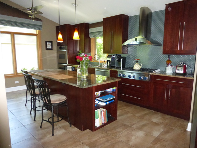 2928 Covert Road Glenview, IL 60025 - Photo 9 of 23 a kitchen with stainless steel appliances granite countertop a stove top oven a dining table and chairs with wooden floor