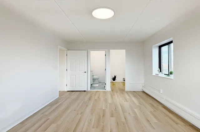 a view of wooden floor and windows in a room
