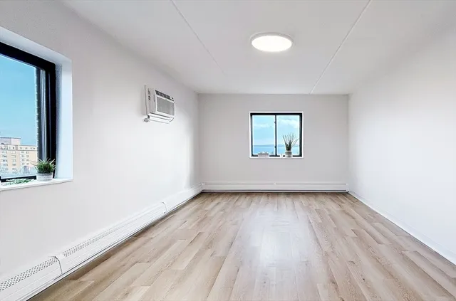 wooden floor in an empty room with a window