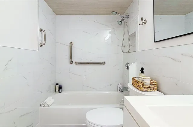 a bathroom with a sink a toilet and bathtub