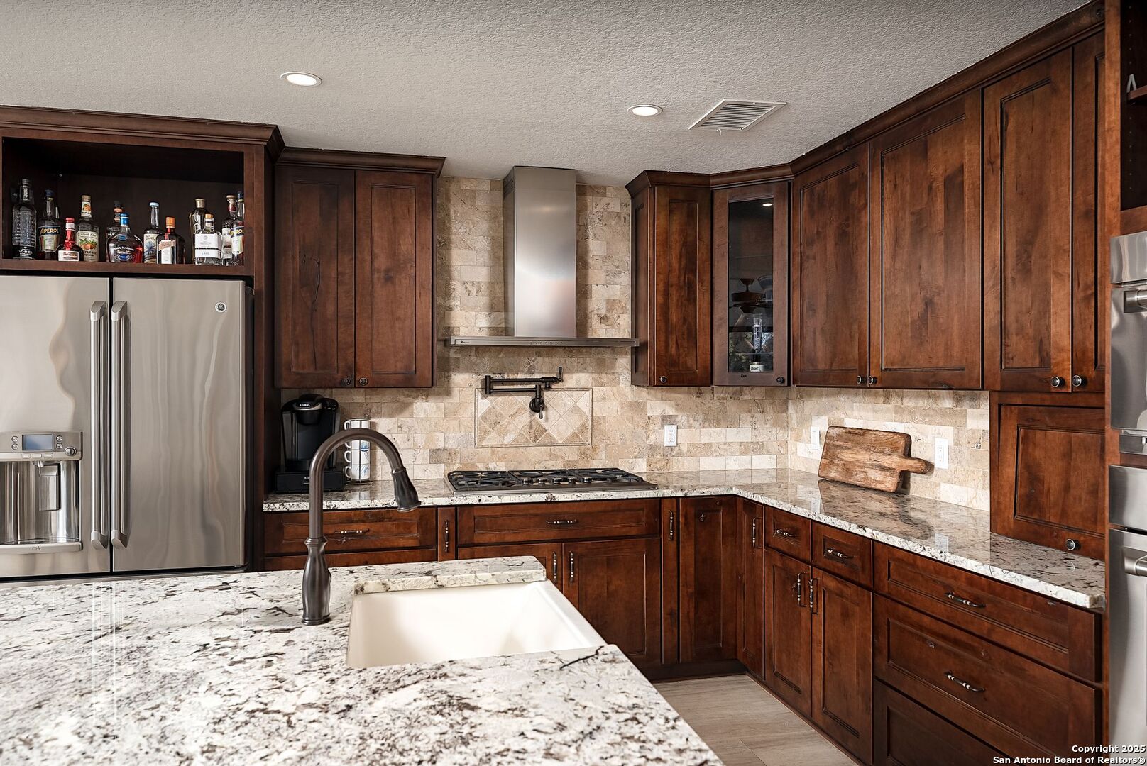 1240 Rip Jay Circle Canyon Lake, TX 78133 - Photo 11 of 52 a kitchen with stainless steel appliances granite countertop a sink stove and cabinets