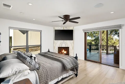 a bedroom with a large bed and a tv