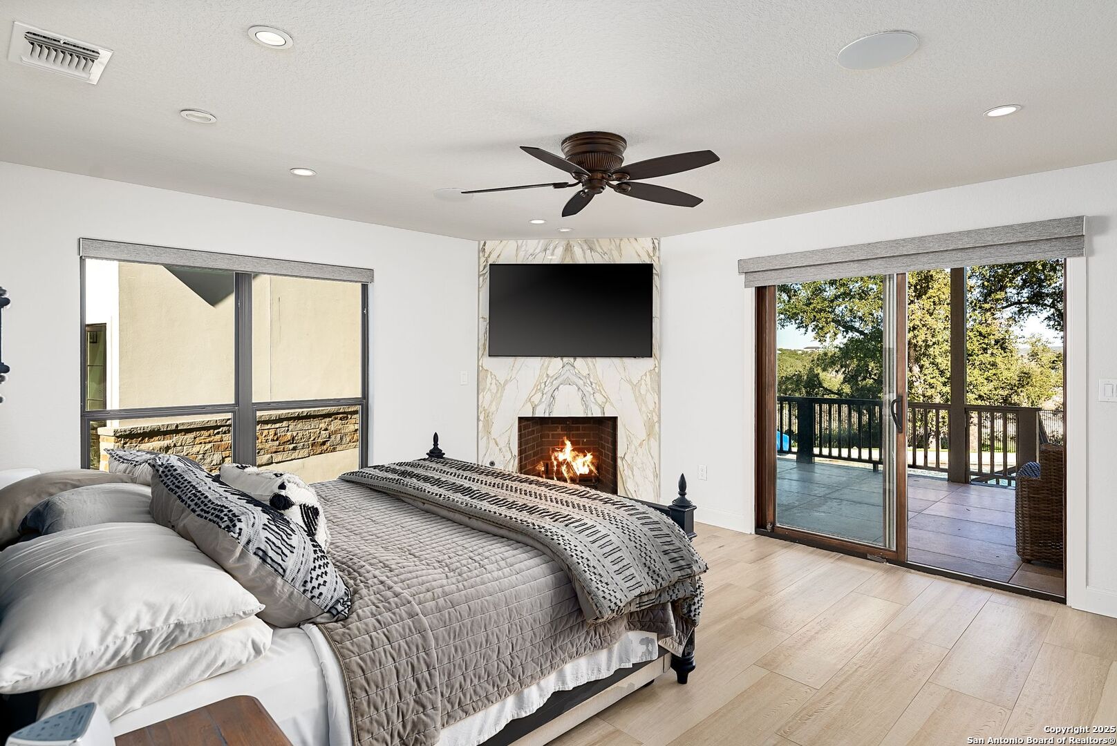 1240 Rip Jay Circle Canyon Lake, TX 78133 - Photo 13 of 52 a bedroom with a large bed and a tv