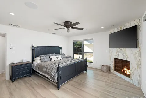 a bedroom with a bed and a fireplace